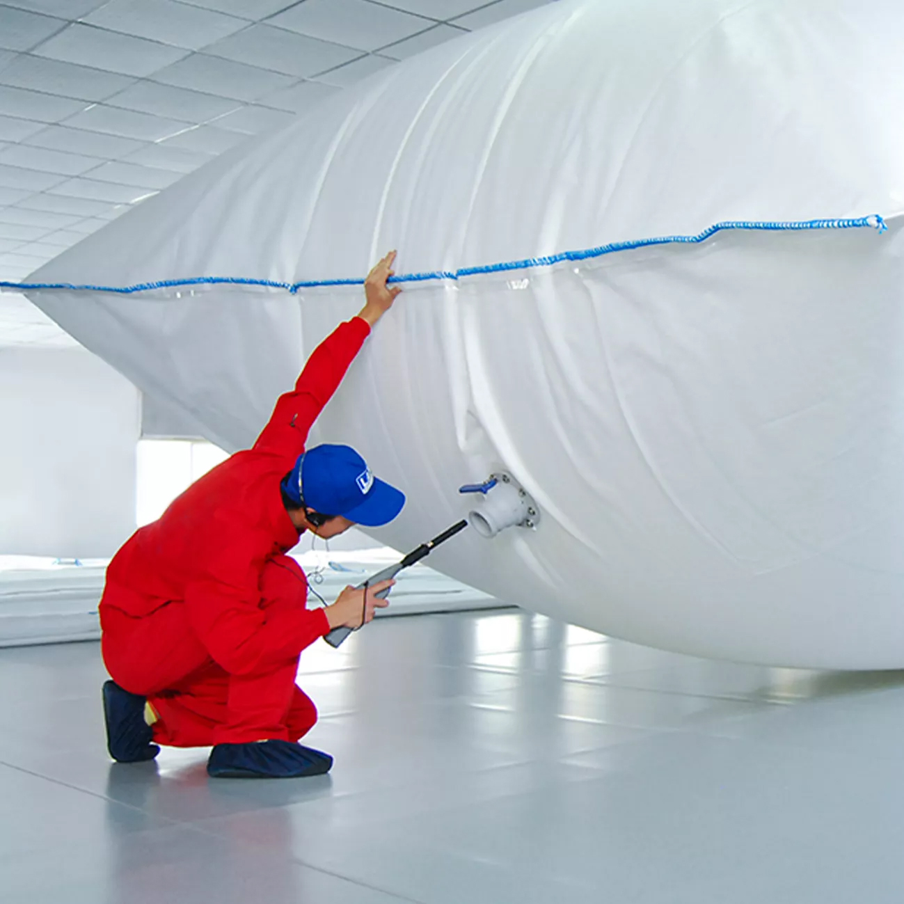 Flexitank quality inspection - technician checking valve and seal integrity